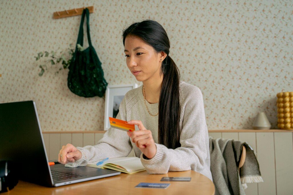 a woman dealing with her online banking on her laptop before she moves abroad