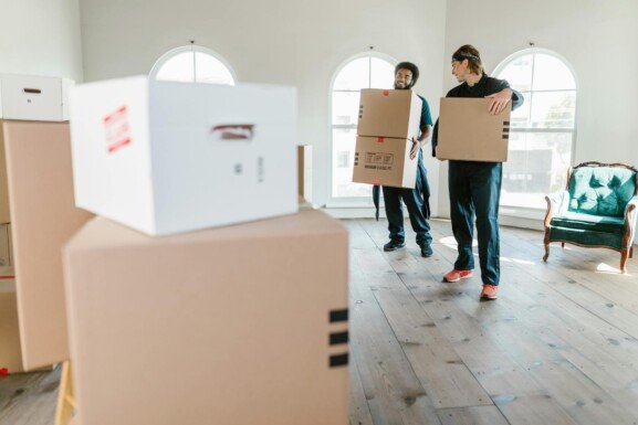 people carrying boxes in making the move from Urban to Rural Life